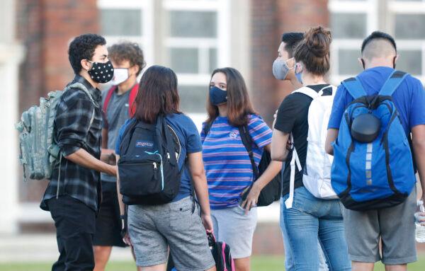 High school students in line to have their temperature checked before entering the building in Tampa, Fla., on Aug. 31, 2020. (Octavio Jones/Getty Images)