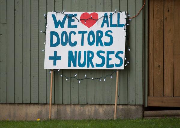 A sign for doctors and nurses is pictured across the street from the Abbotsford Regional Hospital in Abbotsford, B.C., Canada, on April 14, 2020. (Jonathan Hayward/The Canadian Press)