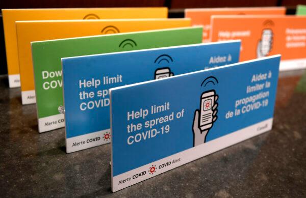 Podium placards promoting the COVID Alert app are seen on a table on Parliament Hill in Ottawa, on July 31, 2020. (Justin Tang/The Canadian Press)