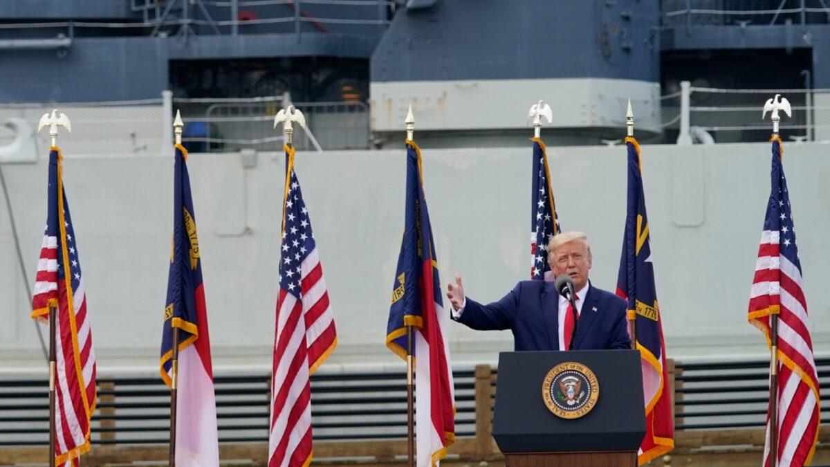With the Battleship North Carolina in the background, President Donald Trump speaks during an event to designate Wilmington as the first American World War II Heritage City in Wilmington, N.C., on Sept. 2, 2020, (Evan Vucci/AP Photo)