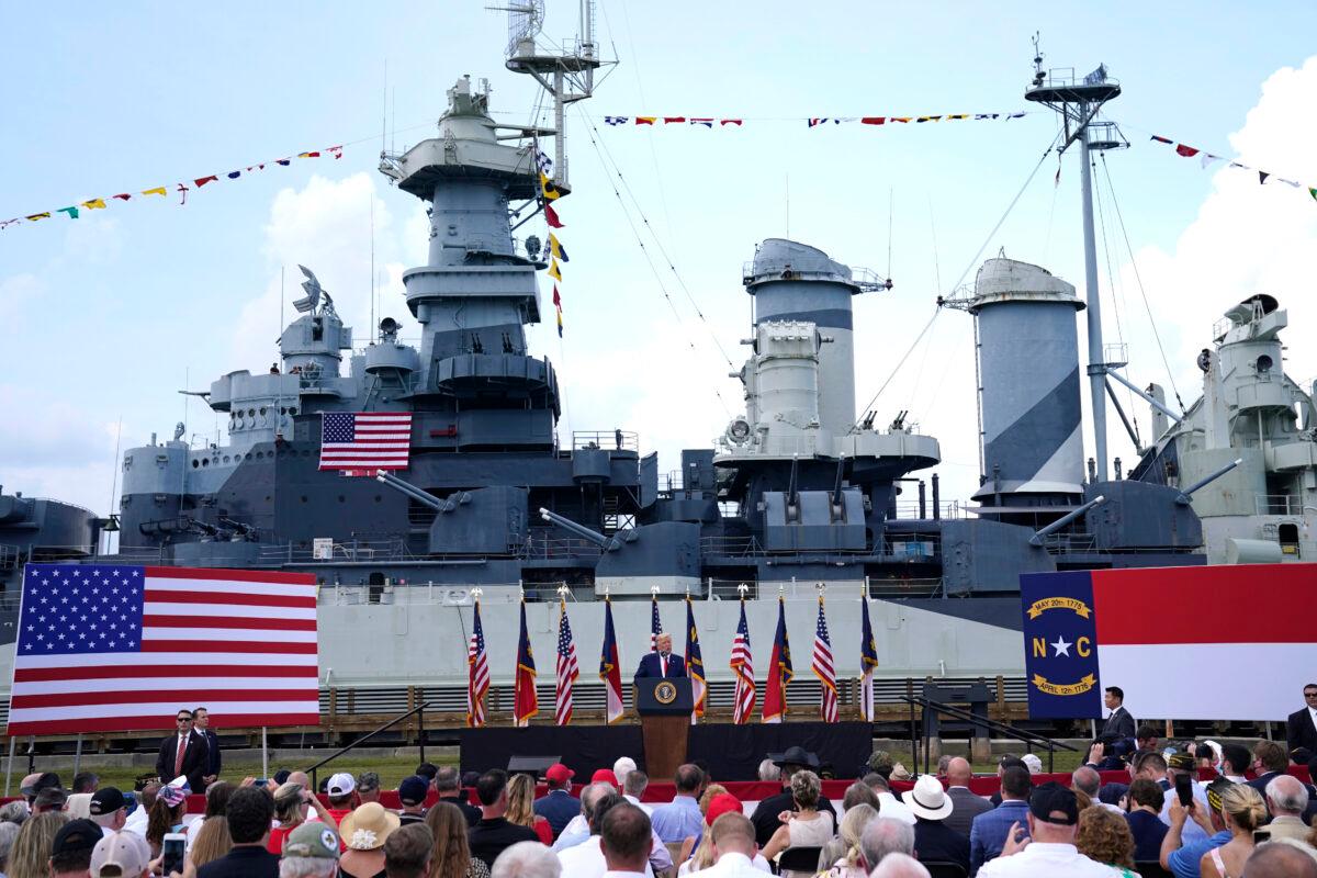 With the the Battleship North Carolina in the background, President Donald Trump speaks during an event to designate Wilmington as the first American World War II Heritage City, in Wilmington, N.C., on Sept. 2, 2020. (Evan Vucci/AP Photo)