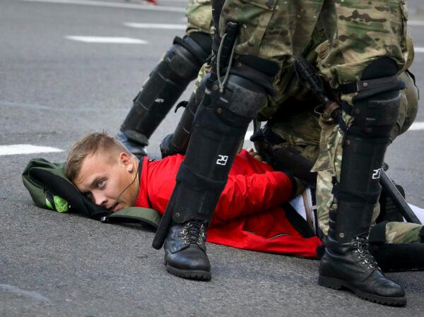 Riot police officers detain a protester during an opposition rally in Minsk, on Sept. 13, 2020. (AP Photo)