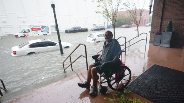 A man watches floodwaters in downtown Pensacola, Fla. on Sept. 16, 2020. (Gerald Herbert/AP)