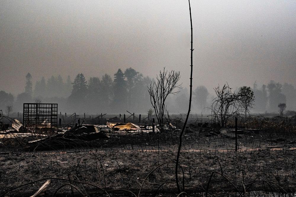 A spot fire smolders near a lumber yard in Molalla, Ore., on Sept. 10, 2020. (Nathan Howard/Getty Images)