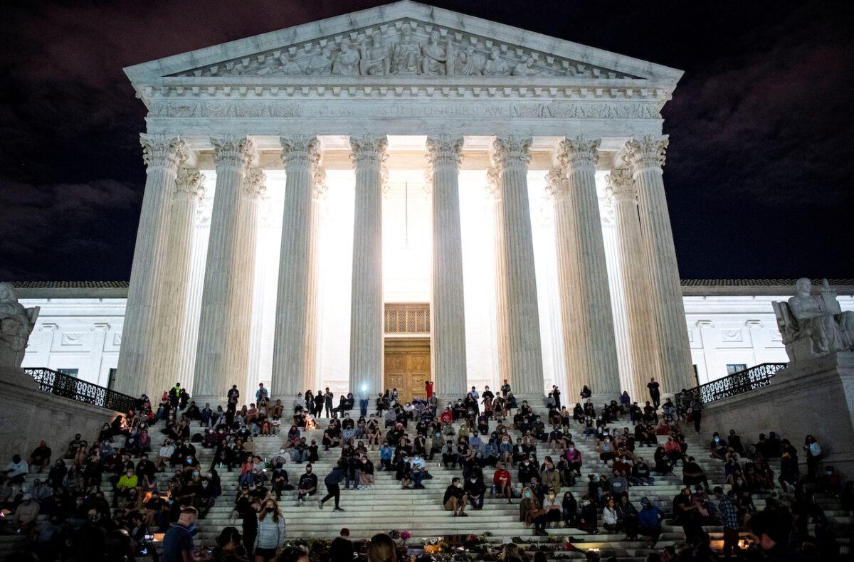 People gather in front of the Supreme Court following the death of Supreme Court Justice Ruth Bader Ginsburg, in Washington, on Sept. 18, 2020. (Al Drago/Reuters)