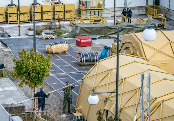Military and personnel from the National Swedish Board of Health and Welfare dismantle a field hospital in Helsingborg, Sweden, on Sept. 9, 2020. (TT News Agency/Johan Nilsson/AP Photo)