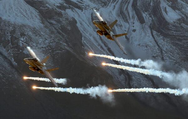 Swiss Air Force F/A18 Hornet fighter jets release flares during a flight demonstration of the Swiss Air Force over the Axalp in the Bernese Oberland, Switzerland, on Oct. 12, 2017. (Arnd Wiegmann/Reuters)