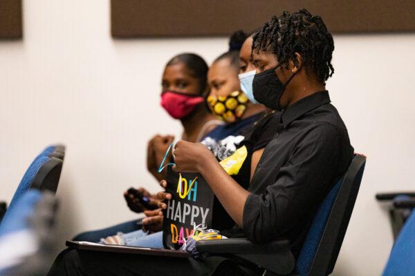 Zamire opens a gift given to him for his graduation from the Young Adult Court program, at the Central Justice Center in Santa Ana, Calif., on Sept. 18, 2020. (John Fredricks/The Epoch Times)