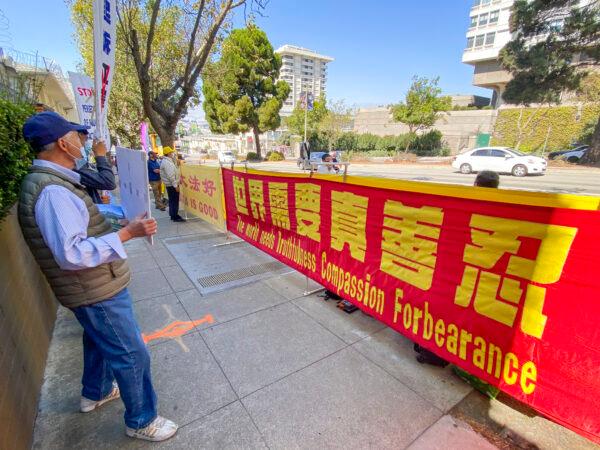 Cars drive past a demonstration in front of the Chinese Consulate in San Francisco calling for an end to the persecution of Falun Gong, on Sept. 21, 2020. (Ilene Eng/The Epoch Times)