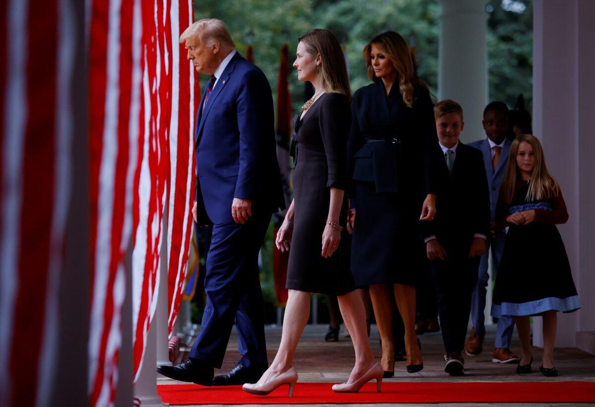 (L–R) President Donald Trump, Judge Amy Coney Barrett, First Lady Melania Trump, and Barrett's family walk to the Rose Garden at the White House on Sept. 26, 2020. (Carlos Barria/Reuters)