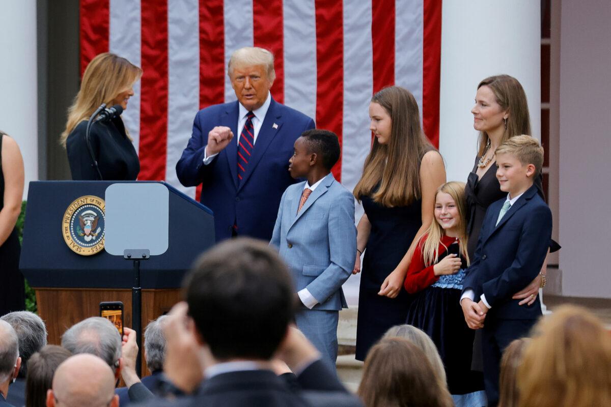 President Donald Trump poses with U.S. Court of Appeals for the 7th Circuit Judge Amy Coney Barrett and her family at an event to announce her as his nominee to fill the Supreme Court seat left vacant by the death of Justice Ruth Bader Ginsburg, at the White House on Sept. 26, 2020. (Carlos Barria/Reuters)