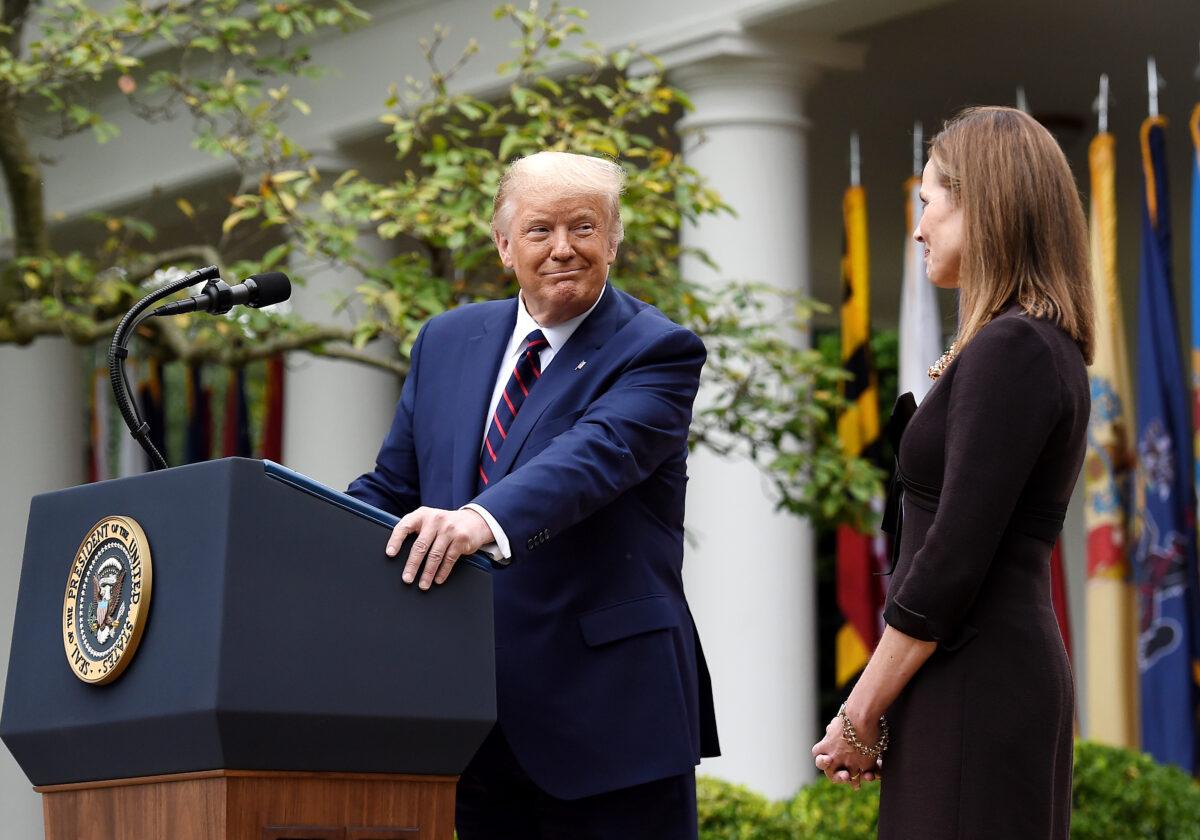 President Donald Trump, left, looks at Judge Amy Coney Barrett, during a ceremony announcing her nomination to the Supreme Court, in the Rose Garden of the White House in Washington, on Sept. 26, 2020. (Olivier Douliery/AFP via Getty Images)