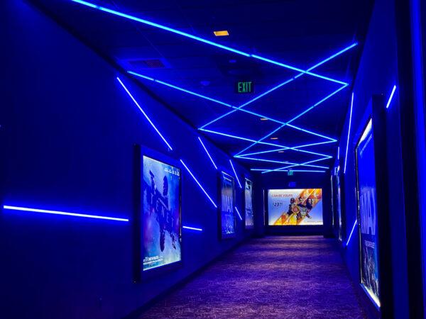 A hallway illuminated by blue LEDs leads to the IMAX theater at Regal Irvine Spectrum, in Irvine, Calif., on Sept. 25, 2020. (Jamie Joseph/The Epoch Times)