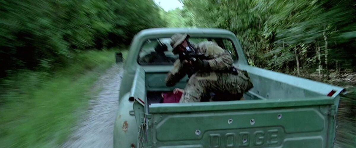 Chief Dave in the back of a pickup, firing at enemy trucks, in "Act of Valor." (Relativity Media)