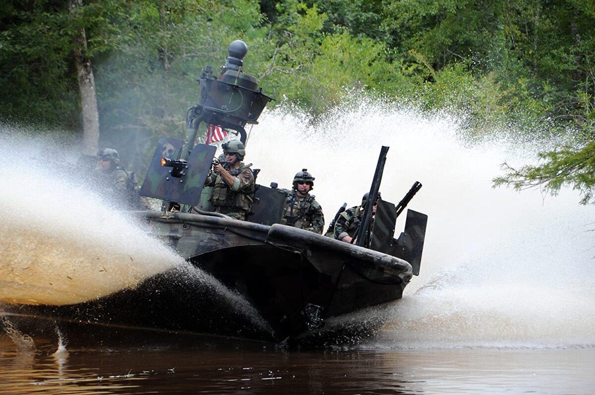 The SWCC (Special Warfare Combatant-Craft) gunboat crew of a SOC-R boat (Special Operations Craft-Riverine) come to their SEAL brothers-in-arms rescue, with guns blazing in "Act of Valor." (Relativity Media)