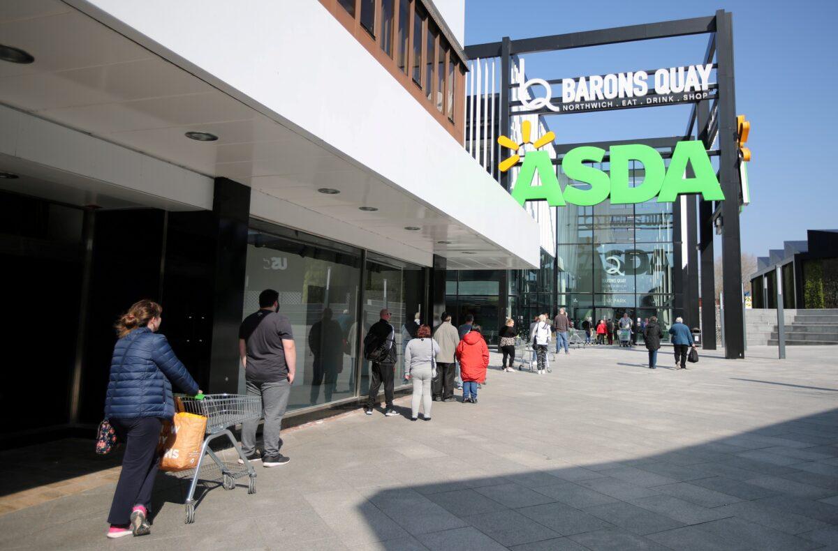 People follow social distancing rules as they queue outside an Asda supermarket as the spread of the coronavirus disease (COVID-19) continues, in Northwich, Britain, on March 27, 2020. (Molly Darlington/Reuters)