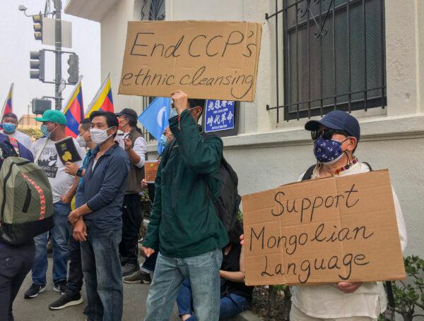 People hold signs at the Chinese Consulate in San Francisco on Oct. 1, 2020, to protest against the CCP’s persecution of minorities. (Ilene Eng/The Epoch Times)