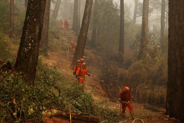 A group of inmate firefighters traverse a slope during the Glass Fire in Calistoga, Calif., on Oct. 2, 2020. (Stephen Lam/Reuters)