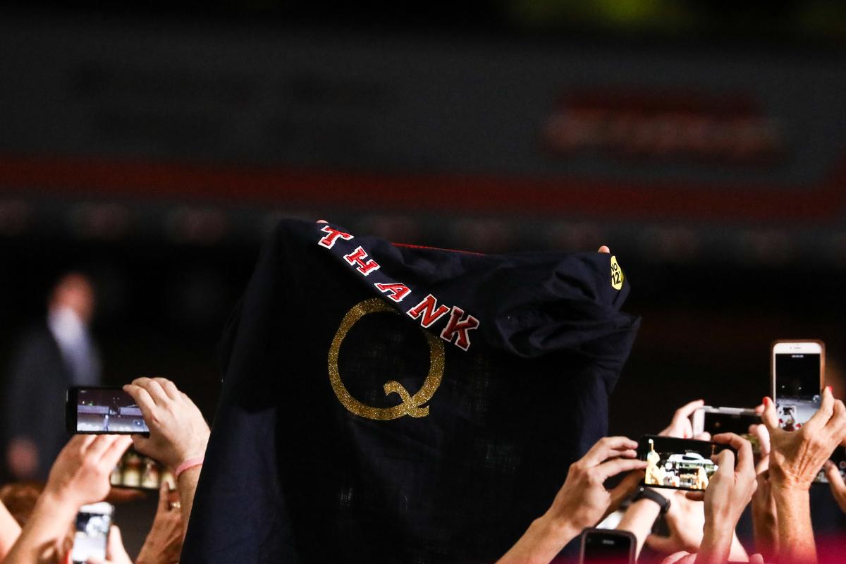 An attendee holds up a Qanon t-shirt at a Make America Great Again rally in Mesa, Ariz., on Oct. 19, 2018. (Charlotte Cuthbertson/The Epoch Times)