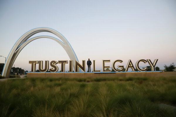 Tustin City Council candidate AJ Jha stands amid the letters on a sign for a partially developed parcel of land known as the Tustin Legacy, in Tustin, Calif. (Courtesy of AJ Jha)