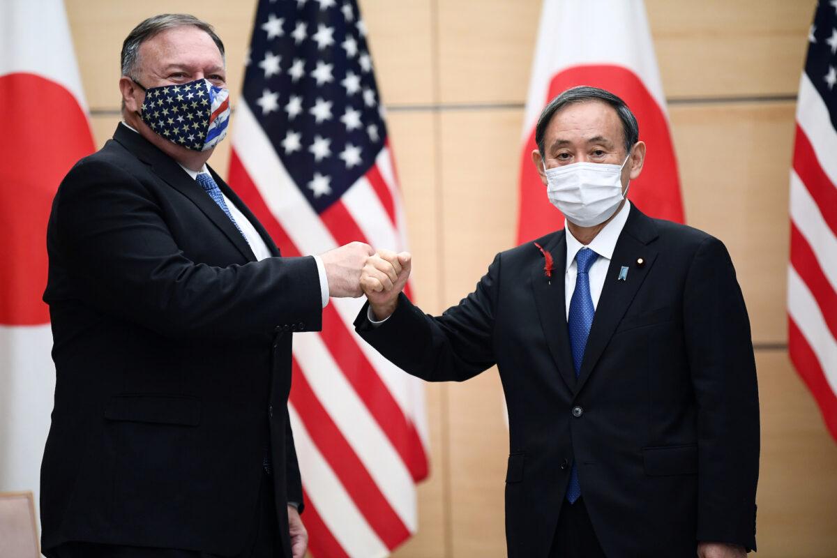 Japan's Prime Minister Yoshihide Suga (R) and Secretary of State Mike Pompeo pose prior to their meeting in Tokyo, Japan, on Oct. 6, 2020. (Charly Triballeau/Pool via Reuters)