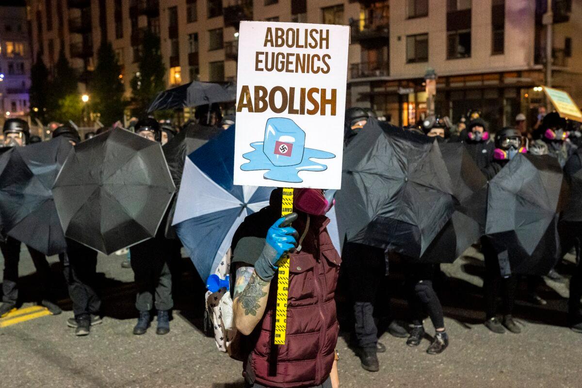 A person holds a sign while marching in Portland, Ore., Oct. 6, 2020. (Nathan Howard/Getty Images)