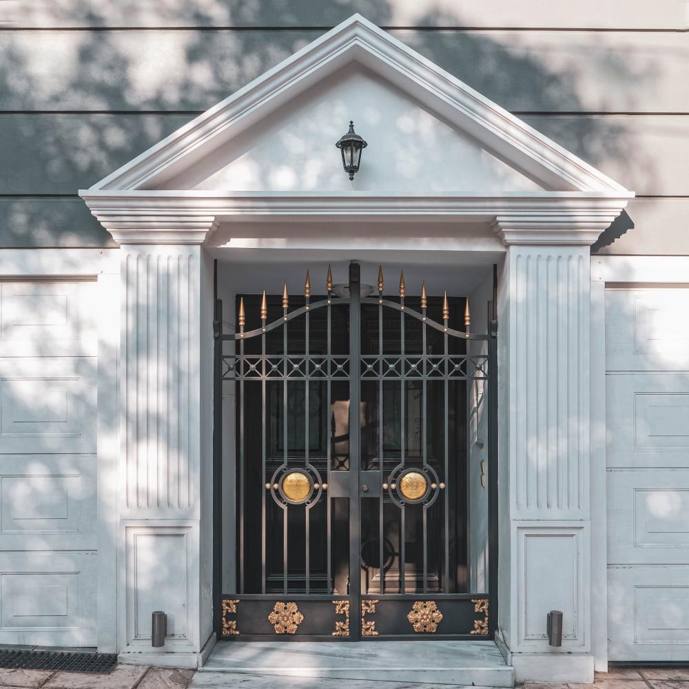 The entrance of a family home is decorated with a pediment. (Dimitrios P/Shutterstock)