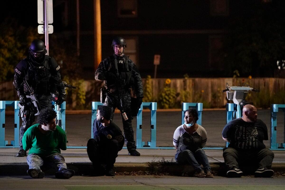 Police detain four people in Wauwatosa, Wis., on Oct. 9, 2020. (Morry Gash/AP Photo)