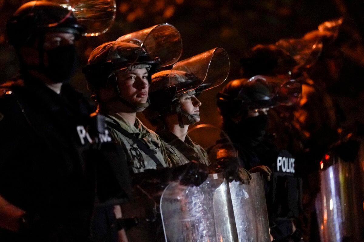 Police and National Guardsmen line up in riot gear in Wauwatosa, Wis., on Oct. 9, 2020. (Morry Gash/AP Photo)