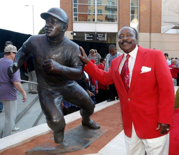 Hall of Fame second baseman Joe Morgan poses with his statue that was unveiled at Great American Ball Park, in Cincinnati, Ohio, on Sept. 7, 2013. (David Kohl/AP Photo)