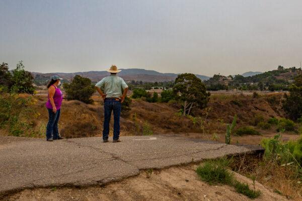 Loral Maldonado and David Hillman, longtime residents of the Orange Park Acres neighborhood of Orange, Calif., look over a swath of land that’s part of a development proposal that will go to voters as Measure AA, on Sept. 10, 2020. (John Fredricks/The Epoch Times)
