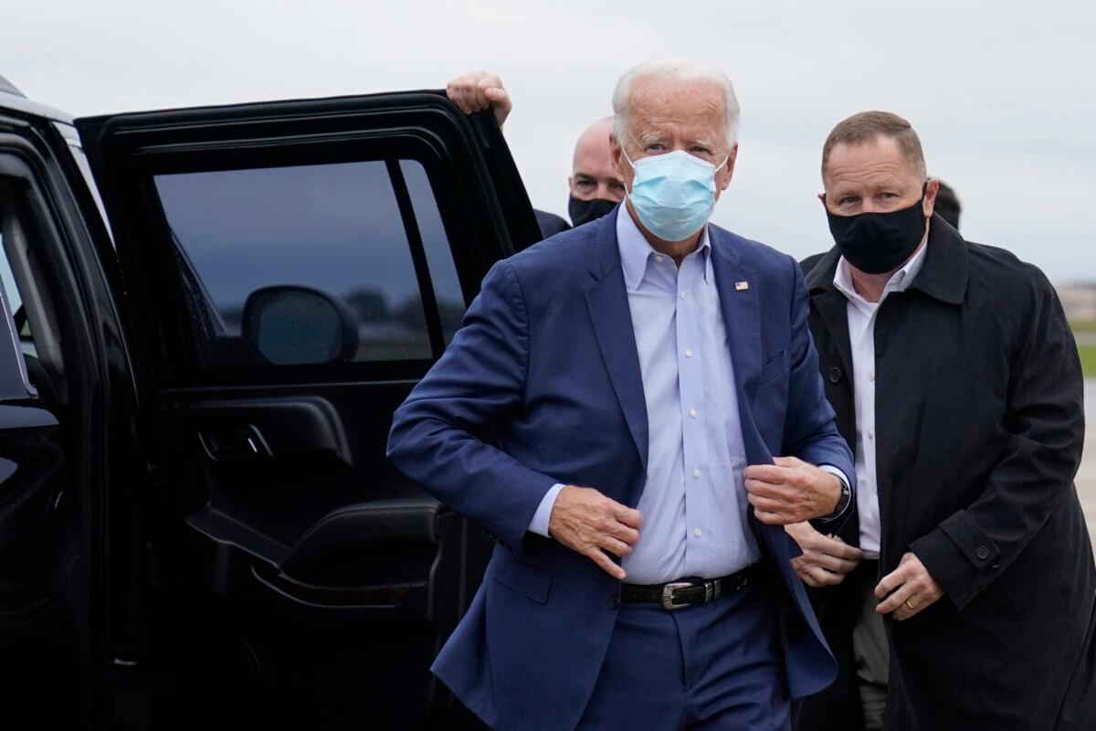 Democratic presidential nominee Joe Biden exits his motorcade to board his campaign plane at New Castle Airport, in New Castle, Del., en route to Ohio, Oct. 12, 2020. (Carolyn Kaster/AP Photo)