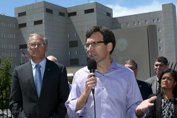 Washington state Attorney General Bob Ferguson speaks at a press conference outside the Federal Detention Center, as Washington state Gov. Jay Inslee (L) and Congresswoman Pramila Jayapal (R) listen, in SeaTac, Washington, on June 9, 2018. (Karen Ducey/Getty Images)