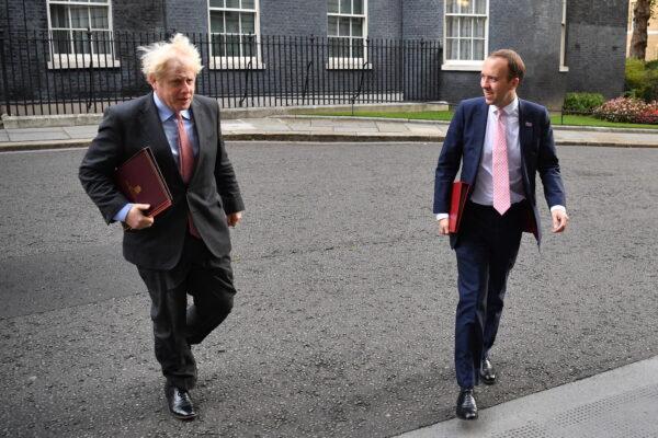Prime Minister Boris Johnson and Secretary of State for Health and Social Care Matt Hancock walk from Downing Street to the Foreign and Commonwealth Office in London on Sept. 30, 2020. (Leon Neal/Getty Images)