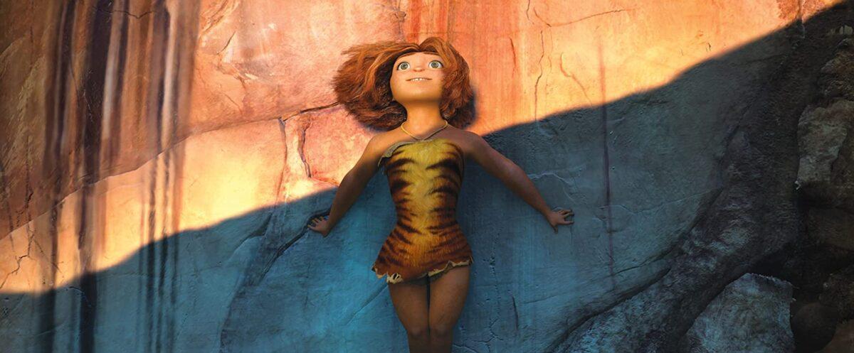 Eep Crood (voiced by Emma Stone) pausing a moment during a rock climb to enjoy a sunset in DreamWorks’ caveman chronicle, “The Croods.” (DreamWorks Animation/Twentieth Century Fox)