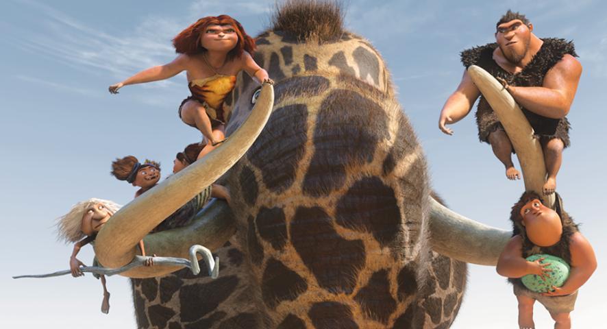 The Crood family ride what appears to be a tusked giraffe-mastodon to safety in DreamWorks' caveman chronicle, “The Croods.” (DreamWorks Animation/Twentieth Century Fox)