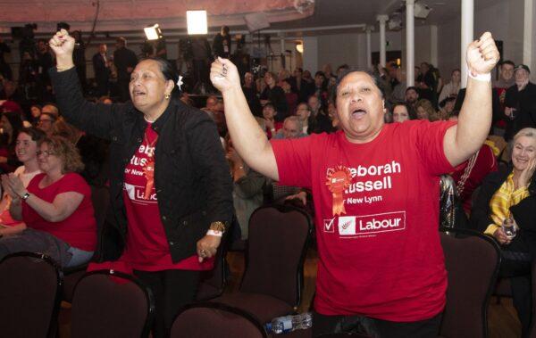 New Zealand Labour Party supporters react as results are showed on a screen at a party event after the polls closed in Auckland, New Zealand on Oct. 17, 2020. (Mark Baker/AP Photo)