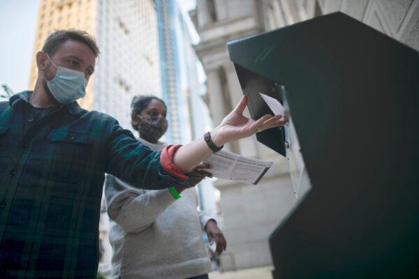 Voters cast their early voting ballot at drop box outside of City Hall in Philadelphia, Pennsylvania, on Oct. 17, 2020. (Mark Makela/Getty Images)