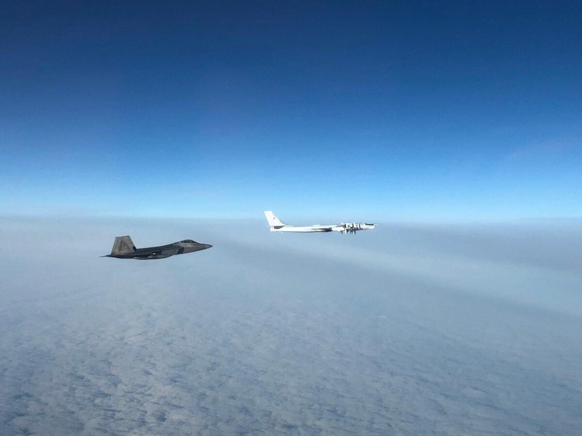 An F-22 "Raptor" fighter jet (under) intercepts a Russian Tu-95 bomber after it entered the Alaskan Air Defense Identification Zone on Oct. 19, 2020. (NORAD)