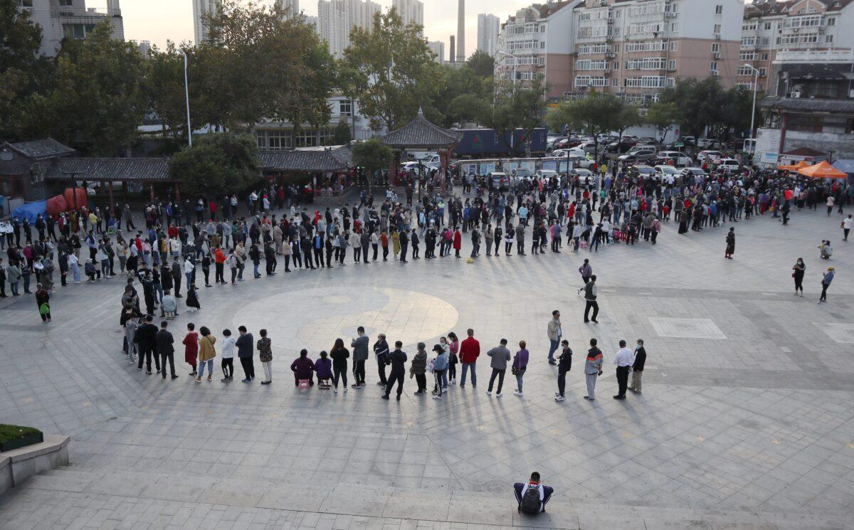 Residents line up to be tested for COVID-19 as part of a mass testing program following a new outbreak in Qingdao, in China's eastern Shandong Province on Oct. 12, 2020. (STR/AFP via Getty Images)