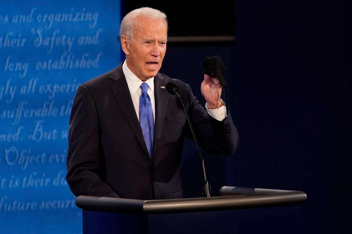 Democratic presidential candidate former Vice President Joe Biden holds up a mask during the second and final presidential debate in Nashville, Tenn., on Oct. 22, 2020. (Morry Gash/ Pool/AP Photo)