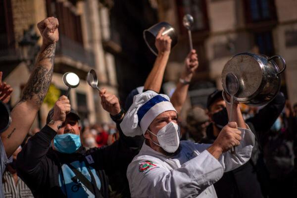Workers of catering sectors take part in a protest organized by restaurants and bar owners against lockdown measures in Barcelona, on Oct. 16, 2020. (Emilio Morenatti/AP Photo)