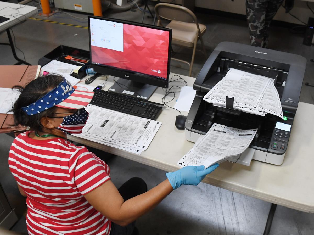 A Clark County election worker scans mail-in ballots at the Clark County Election Department in North Las Vegas, Nev., on Oct. 20, 2020. (Ethan Miller/Getty Images)