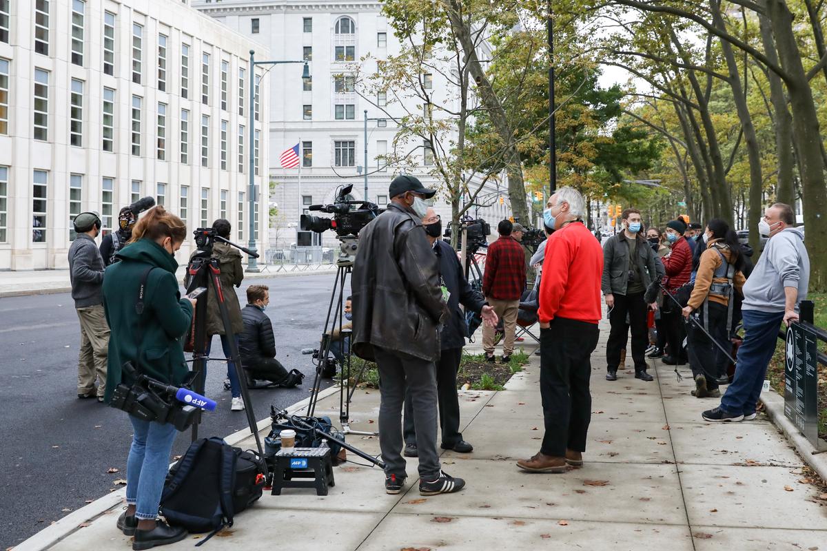 Reporters and photographers wait outside of U.S. District Court for the Eastern District of New York on Oct. 27, 2020. (Chung I Ho/The Epoch Times)