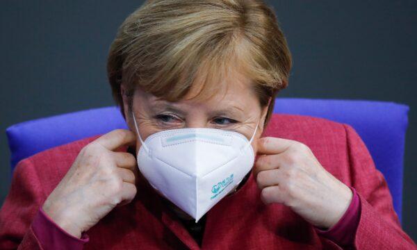 German Chancellor Angela Merkel adjusts her face mask as she arrives for a speech about the German government's policies to combat the spread of the CCP virus and COVID-19 disease at the parliament Bundestag, in Berlin, on Oct. 29, 2020. (Markus Schreiber/AP Photo)