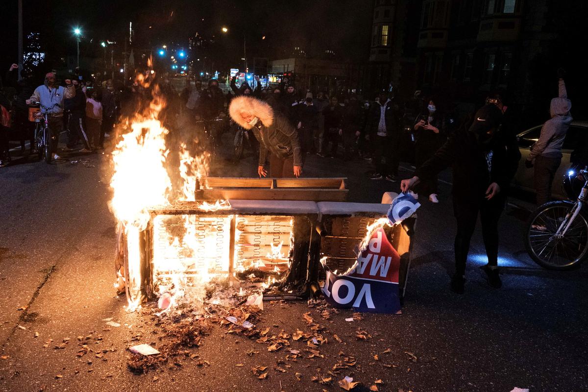 A fire is seen as people clash with police in Philadelphia, Penn., on Oct. 27, 2020. (Yuki Iwamura/Reuters)