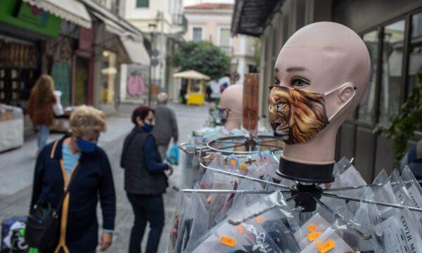 Women walk past a dummy wearing a mask in central Athens on Oct. 29, 2020. (Petros Giannakouris/AP Photo)