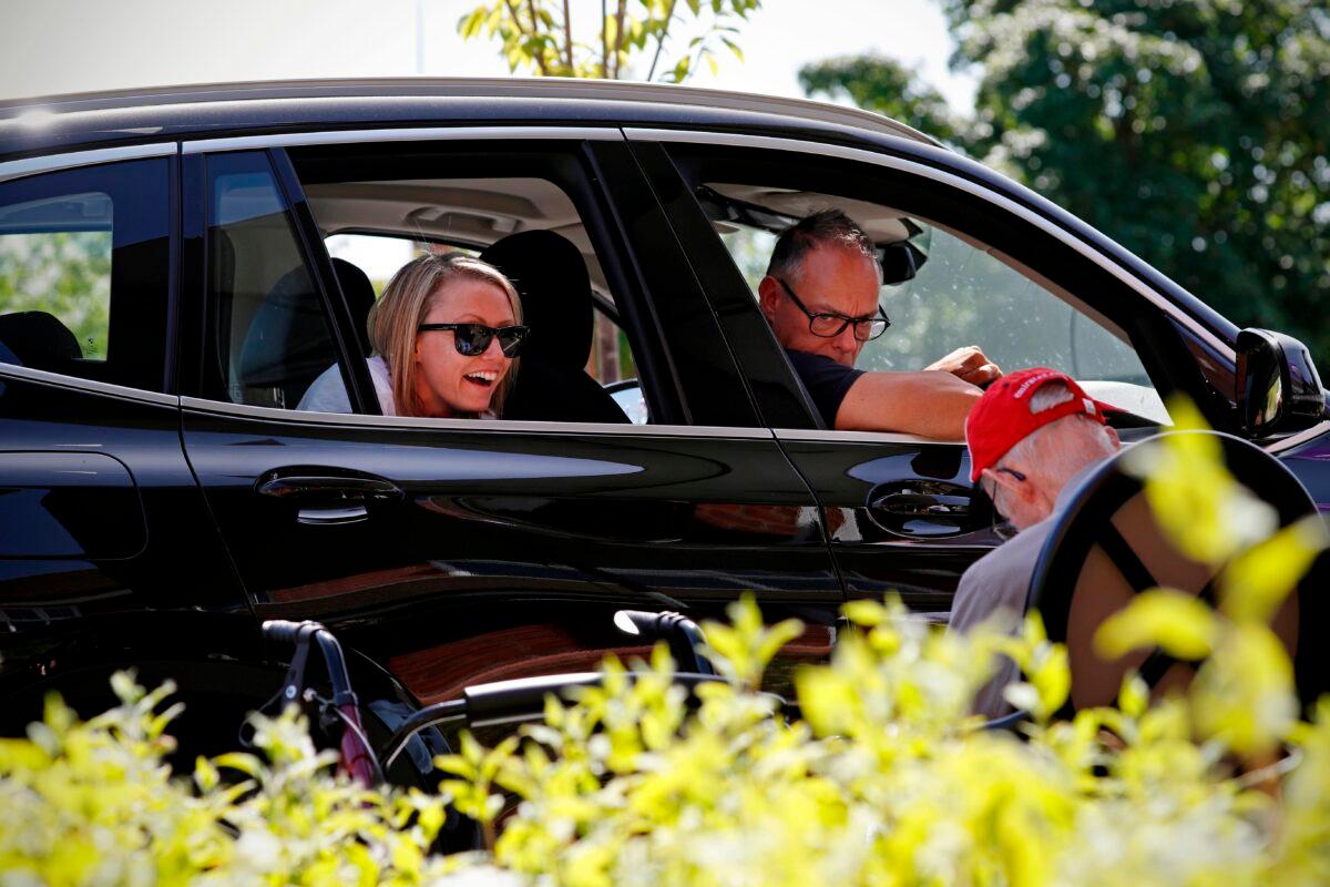 A woman laughs as she speaks with her grandad during a drive-through visit at a residential care home near Banbury, west of London, on May 28, 2020. (Adrian Dennis/AFP via Getty Images)