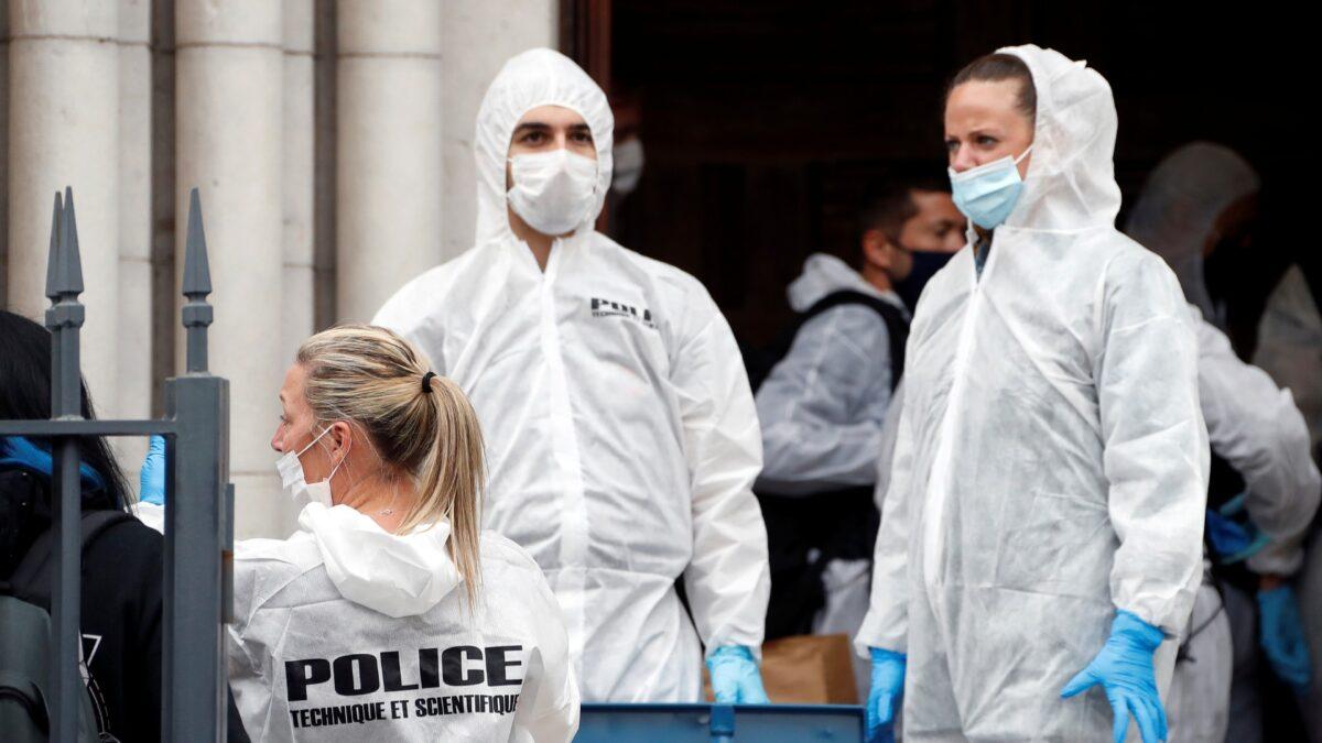 Forensic police officers inspect the scene of a knife attack at Notre Dame church in Nice, southern France, on Oct. 29, 2020. (Eric Gaillard/Pool via AP)