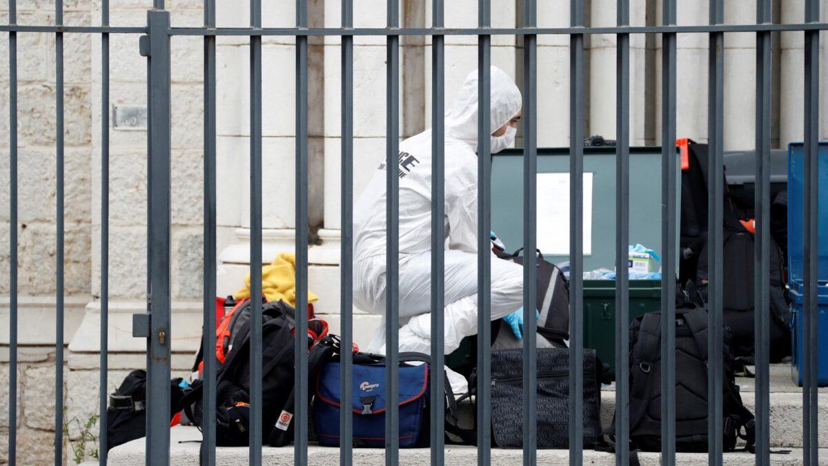 A forensic police officer works at the scene of a knife attack at Notre Dame church in Nice, southern France, on Oct. 29, 2020. (Eric Gaillard/Pool via AP)